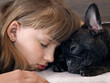 Girl and dog face to face. She sleeps. Friendship girl and dogs. The concept of friendship, love, trust and human animal 