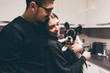 Young beautiful couple indoor in their aparment holding french bulldog puppy - family, animal, together concept