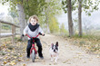 child riding bike with dog